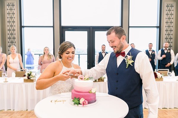 Couple Cutting Cake at wedding reception