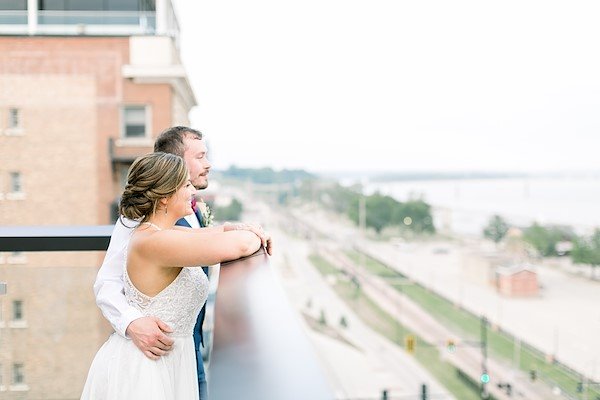 Newly weds on balcony overlooking the Mississippi River
